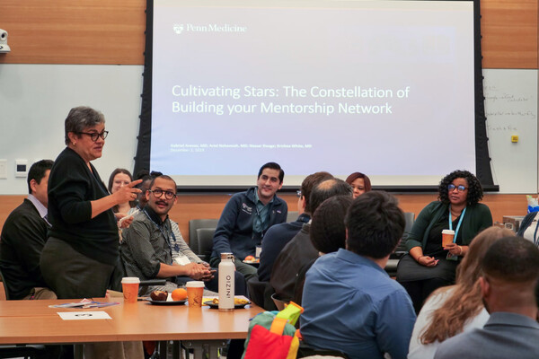 A person addressing a crowd at the 2023 Pathways to Excellence Med Immersion Day.