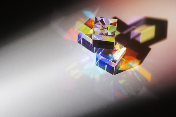 Three glass cubes with light passing through.