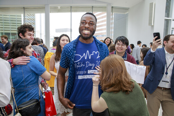 A Penn Med student has their shirt written on on Penn Med’s Match Day.