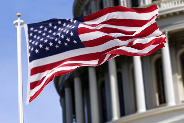 The American flag in front of the U.S. Capitol.