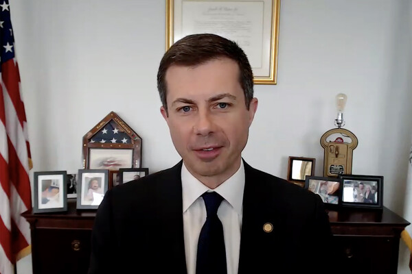 Transportation Secretary Pete Buttigieg sits at his desk in Washington, D.C.