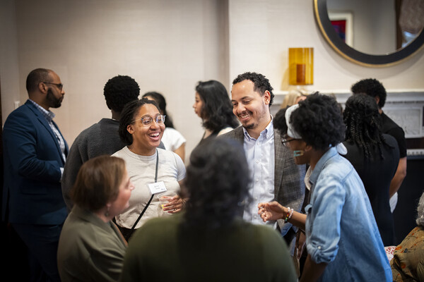 PhD Fellows chat at a reception
