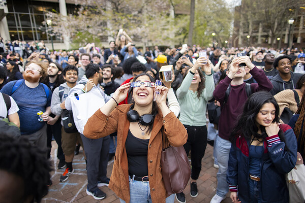 A large group of people gathered to watch the solar eclipse on College Green.