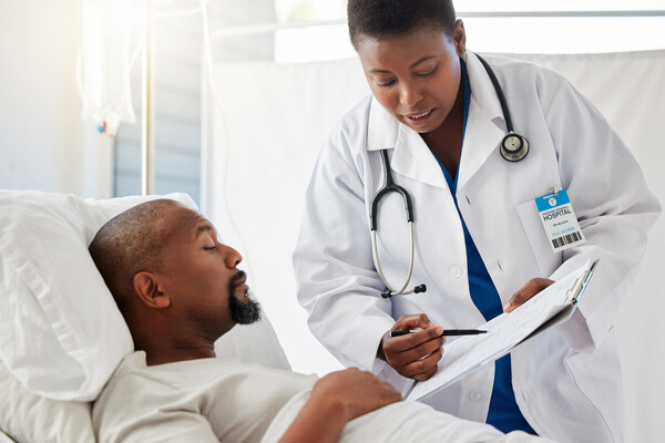A cancer doctor and patient looking at medical forms.