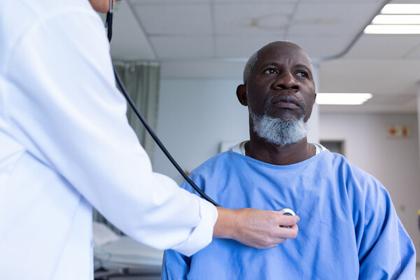 A patient having their heartbeat checked by a doctor.