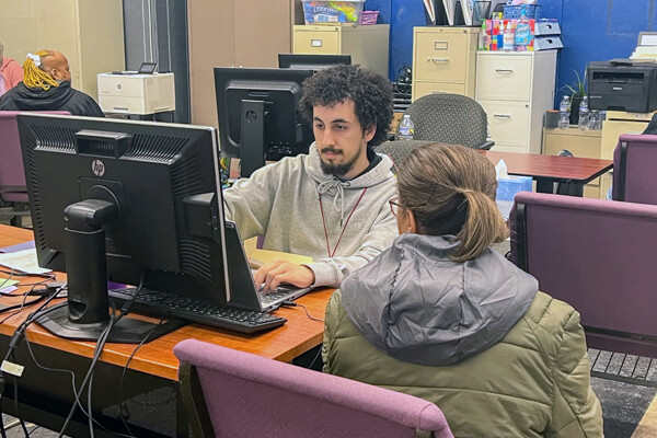Diego Resto helps a community member file their taxes.