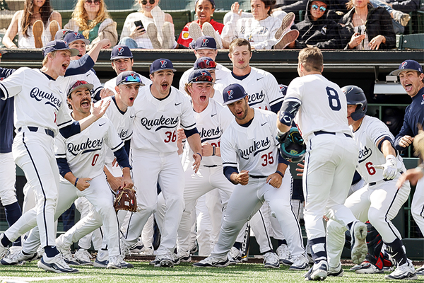 Members of the baseball team celebrate at home plate after a big play.
