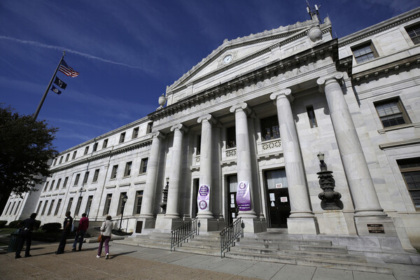 Image is of the Delaware County courthouse, a Classical Revival/Neo-Classical style building made of white marble,with a six column portico and clock in the pediment, located in Media, Pennsylvania.