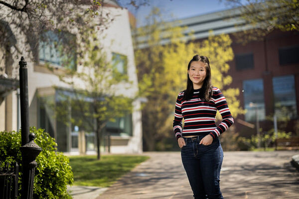 Jing-Jing Piriyalertsak standing outside a building with trees