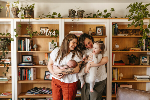 Ashlee Rineer (right) is holding Eleanor who is two years old this month and her partner Lauren (left) is holding Edie.