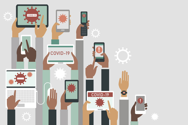 Many hands holding smartphones and other sources of information about COVID-19.