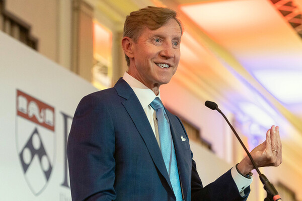 Penn president J. Larry Jameson speaking at a microphone in London.