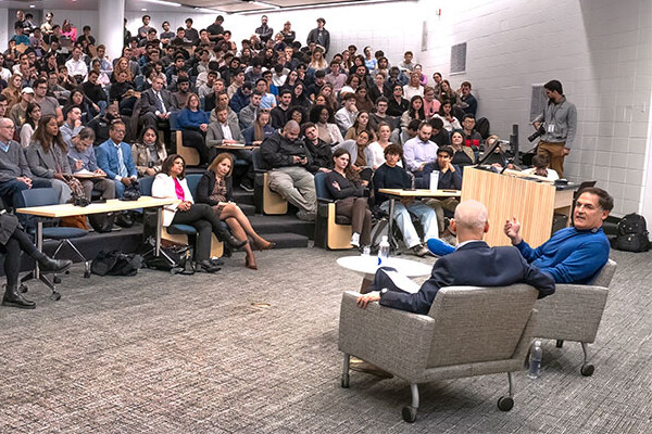 Zeke Emanuel and Mark Cuban in discussion in front of an audience.