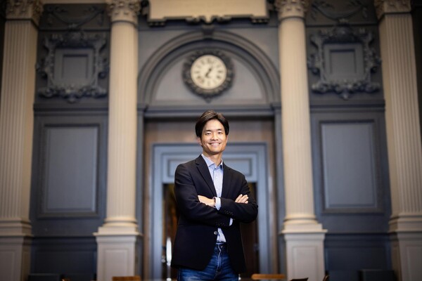 Jaehyung Ahn stands in a large room.