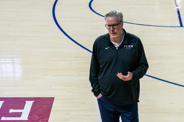 Coach Fran McAffery on a basketball court.