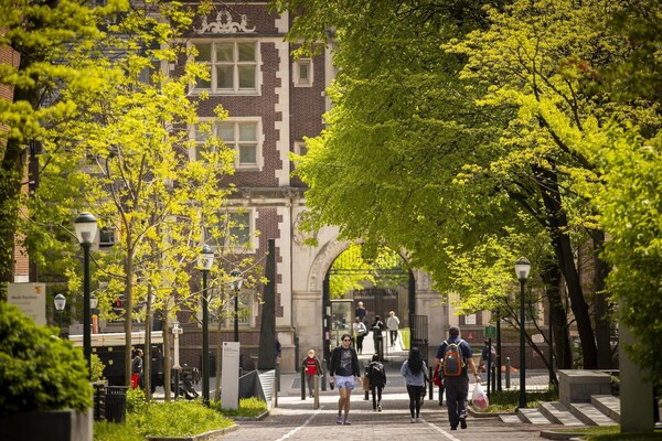 students walking in front of quad gate