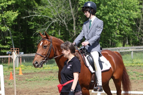A young rider on Rusty the horse.