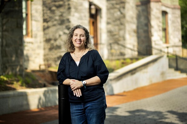 Ann Vernon-Grey standing outside College Hall. 