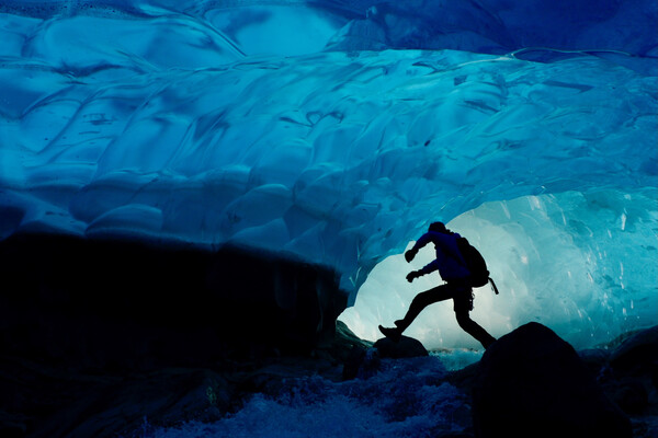 A researcher walking through a glacier in Greenland.