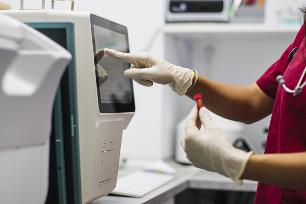 A lab worker with a blood sample in the lab.