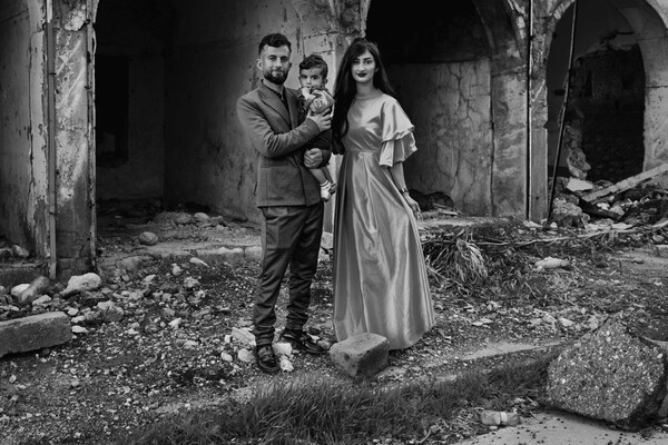 Khalaf and Hamdya pose with their son Hegar in Sinjar’s old district.