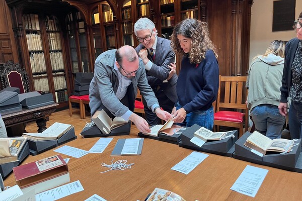 Students and faculty look at rare books in the Lea Library.