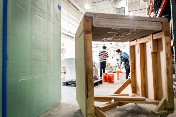 Two workers in a lab working on cooling structures.
