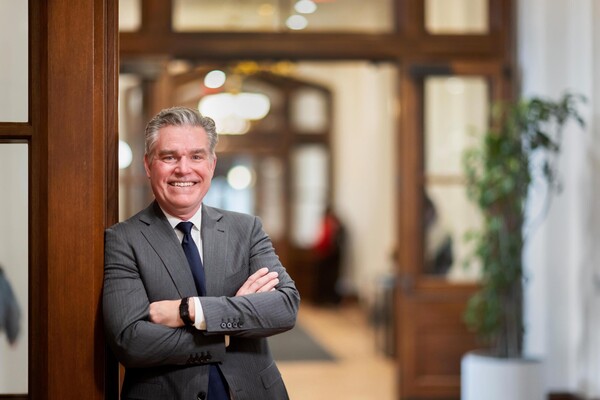 David Meaney leaning against a door in Penn's College Hall.