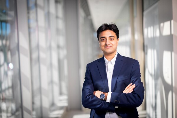 Fourth-year student Prithvi Parthasarathy standing with arms crossed in the Neural and Behavioral Sciences Building