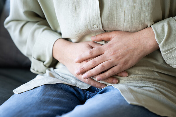 A person holding their stomach.