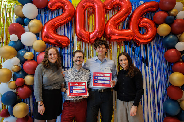 Two Penn Med students and two others under a 2026 balloon at Penn’s 2026 Match Day.