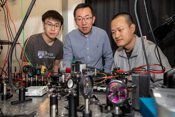 (From left) Xilin Feng, Liang Feng, and Tianwei Wu in an engineering lab.