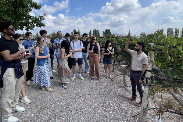 Students listen to explanation at winery.