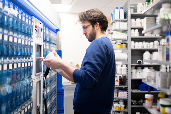 A pharmacist retrieving medication at the pharmacy.