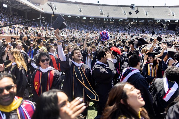 Graduates cheering on franklin field during commencement