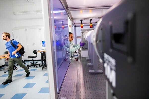 Two people in a lab in the Singh Center.