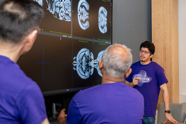Rohit Jena in front of computer monitors.