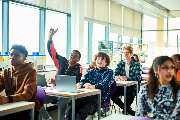 A high school classroom with kids in class at their desks.