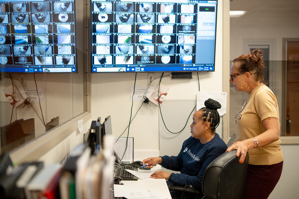 Stephanie Hollister and another healthcare workers at HUP Cedar looking at a computer.