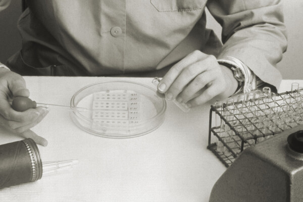 A lab tech with a pipette and petri dish during the Legionnaires disease outbreak of 1976.