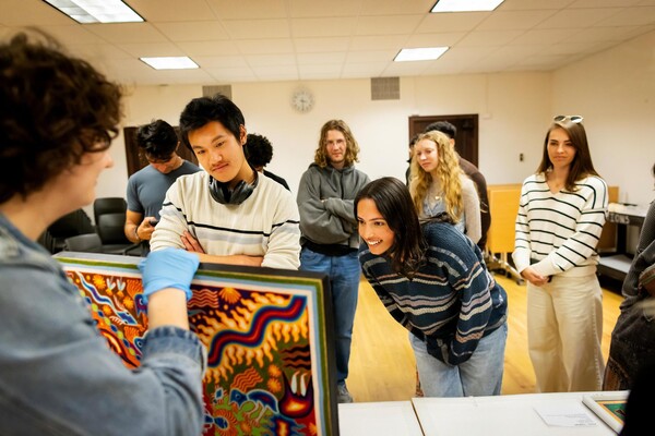 Students looking at artwork in a class.
