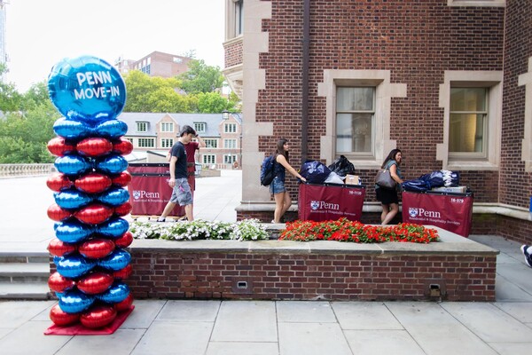 Students pushing Move-In carts into a College House.