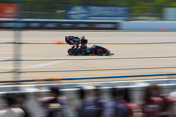 Penn Electric Racing’s REV11 car racing on a track.