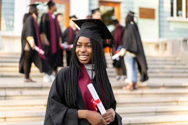 A high school graduate in a cap and gown.