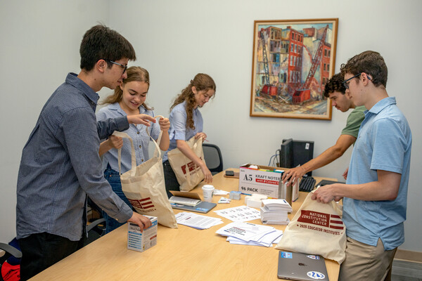 Five SAS interns filling tote bags at the National Constitution Center.