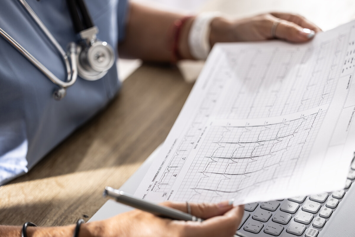 A doctor looking at EKG heart data.
