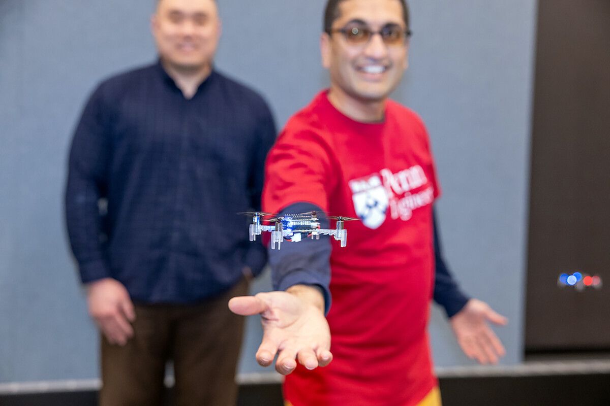 Ph.D. student, Hongrui Zheng (left), and Rahul Mangaharam (right) flying drones.