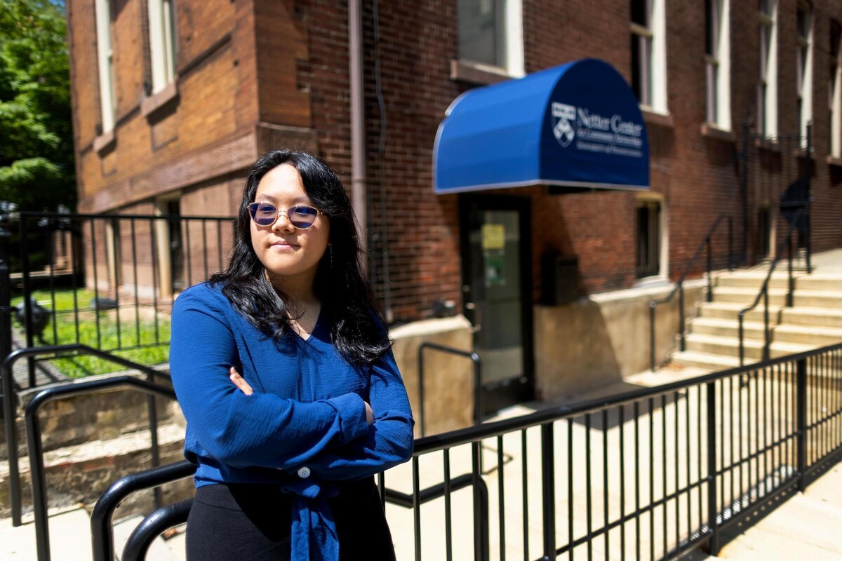 Renee Liu standing outside of the Netter Center office with arms crossed